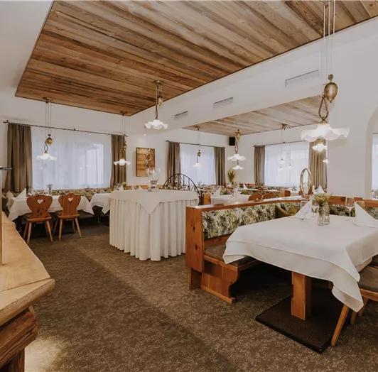 Ein gemütliches Restaurant mit Holzdekor und elegant eingedeckten Tischen.