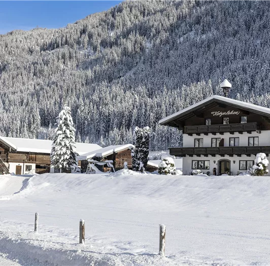 Der Bauernhof im tiefsten Winter umhüllt von einer eisigen Schneedecke