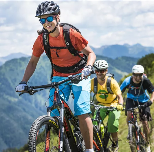 Eine Gruppe von Radfahrern fährt einen Bergweg entlang.