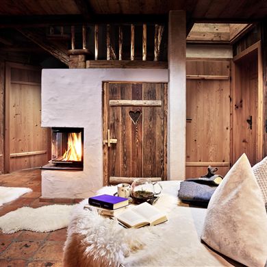 Urlaub im Chalet – Ihr Rückzugsort in den Bergen. Entfliehen Sie dem Alltag und genießen Sie unvergessliche Tage in unserem liebevoll eingerichteten Chalet. Knisterndes Feuer im Kamin, natürliche Materialien aus Holz und Stein sowie kuschelige Felle schaffen eine warme Wohlfühlatmosphäre. Lassen Sie sich in weiche Kissen sinken, lesen Sie ein gutes Buch oder genießen Sie eine Tasse Tee bei flackerndem Kaminlicht. Ob romantische Auszeit zu zweit, erholsamer Wellnessurlaub oder gemütliches Beisamm